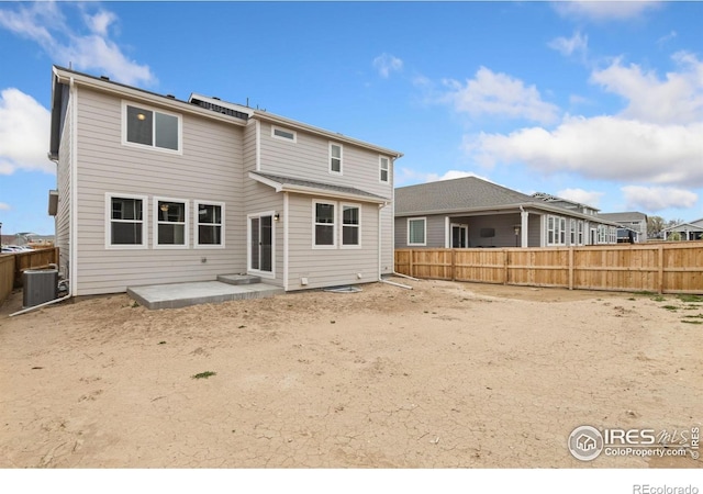 back of house featuring a patio, a fenced backyard, and central AC