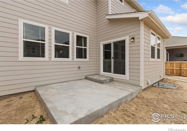 back of property with a patio and fence