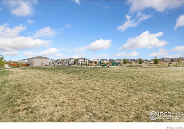 view of yard with a residential view and a playground