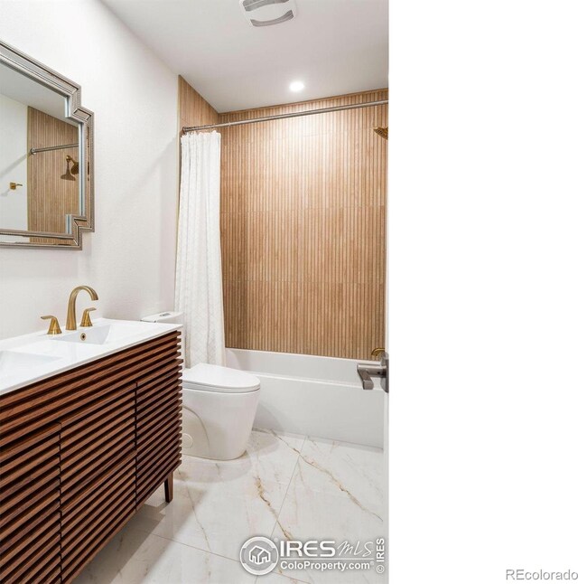 bathroom with vanity, shower / bath combo, and toilet