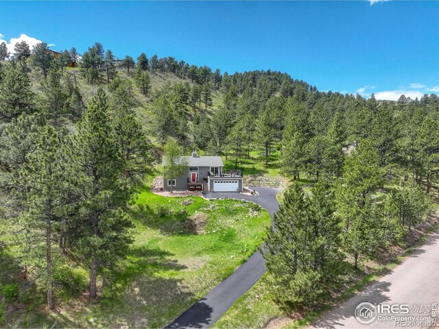 birds eye view of property with a view of trees
