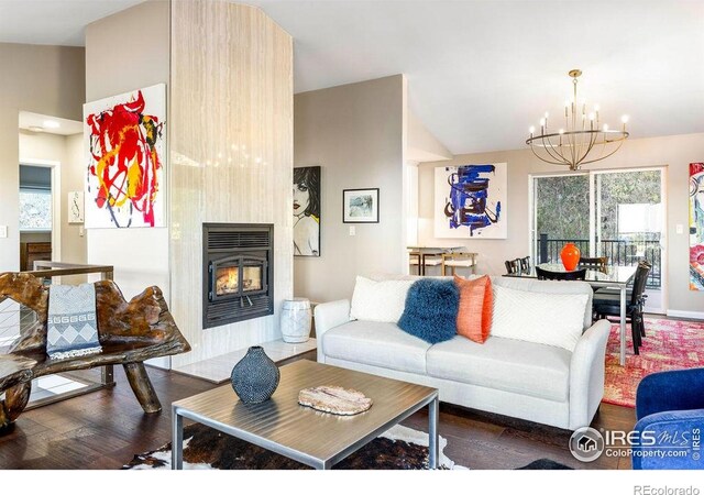 living room featuring a notable chandelier, a healthy amount of sunlight, and wood finished floors
