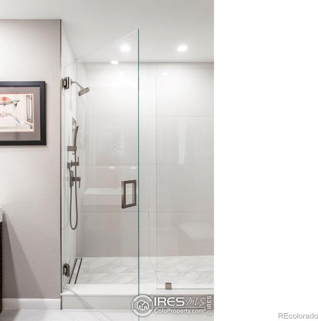 full bath with recessed lighting and a shower stall