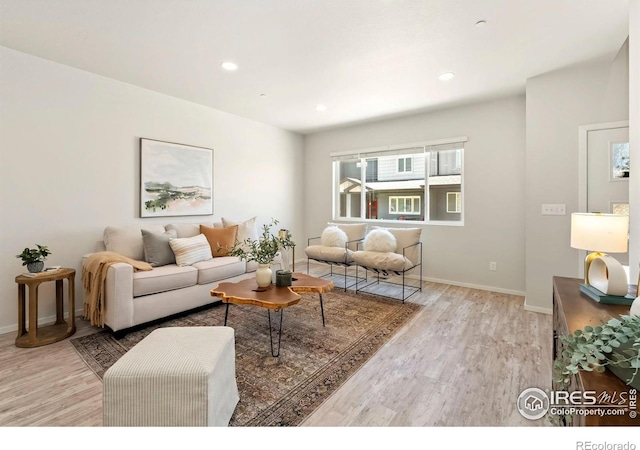 living area featuring recessed lighting, baseboards, and wood finished floors