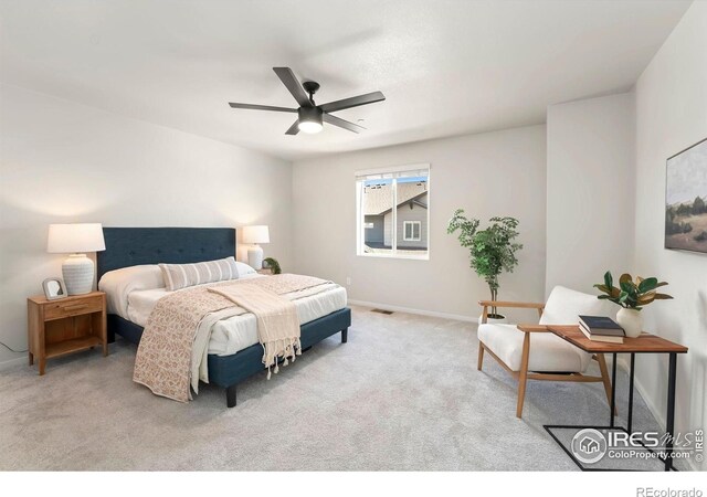 carpeted bedroom with baseboards, ceiling fan, and visible vents