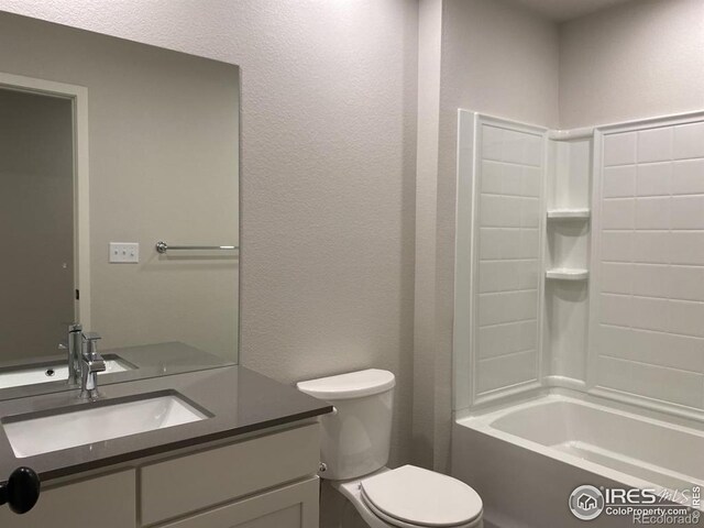 bathroom featuring vanity, bathing tub / shower combination, and toilet
