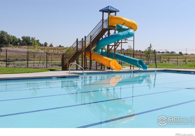 community playground featuring a community pool and fence