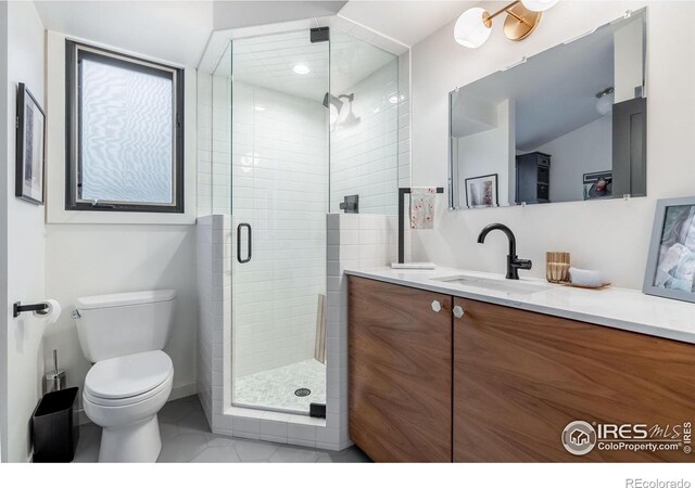 full bathroom featuring vanity, toilet, tile patterned flooring, and a stall shower