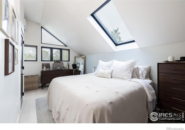 bedroom with vaulted ceiling with skylight