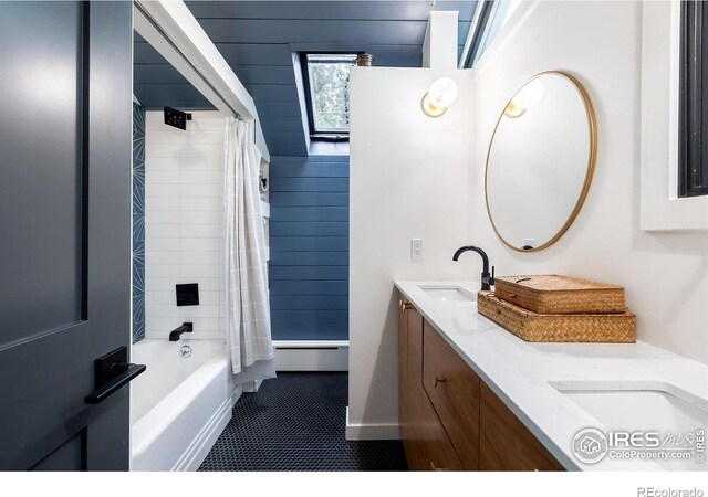 bathroom featuring a sink, tile patterned floors, baseboard heating, and double vanity