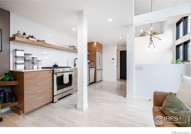 kitchen with light wood-style floors, appliances with stainless steel finishes, modern cabinets, and open shelves