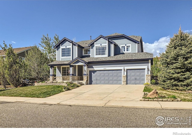910 Pope Dr, Erie, CO 80516 - view of front of home featuring a garage, a front lawn, stone siding, concrete driveway, and a porch