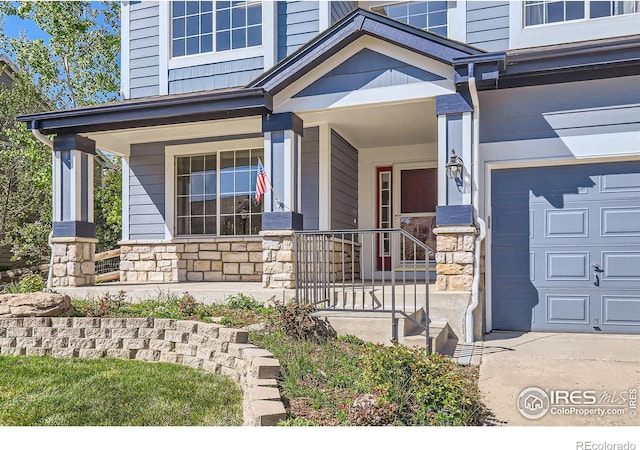 910 Pope Dr, Erie, CO 80516 - property entrance featuring covered porch and stone siding