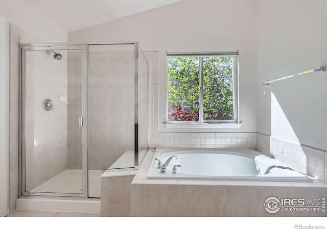 910 Pope Dr, Erie, CO 80516 - bathroom featuring a shower stall, a bath, and lofted ceiling