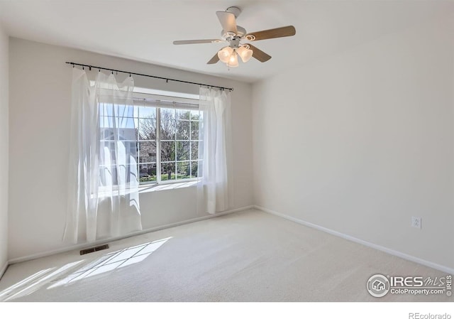 910 Pope Dr, Erie, CO 80516 - spare room featuring baseboards, carpet, a ceiling fan, and visible vents
