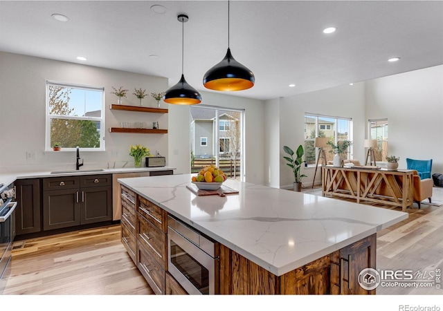 kitchen featuring a sink, appliances with stainless steel finishes, light wood-style floors, and recessed lighting