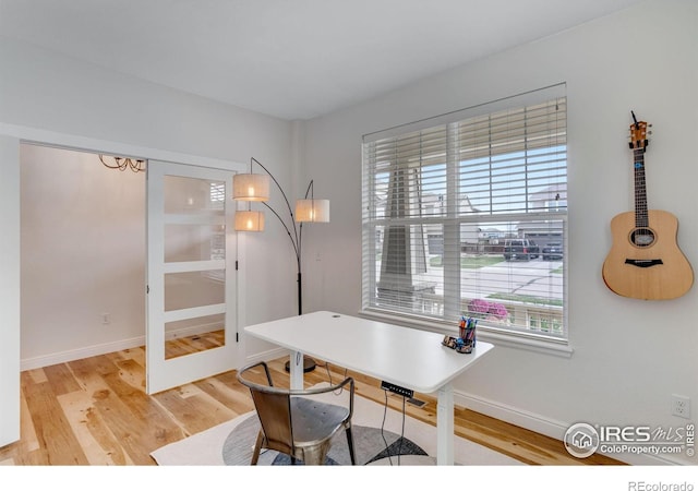 office area featuring baseboards and wood finished floors