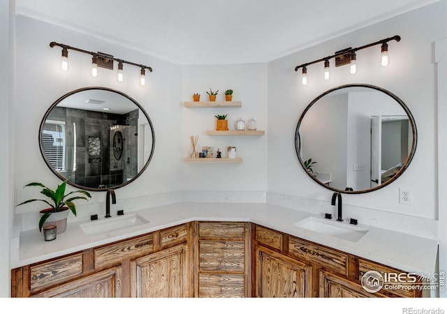 bathroom featuring double vanity, a sink, and a shower with shower door