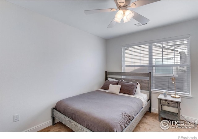 carpeted bedroom with baseboards and a ceiling fan