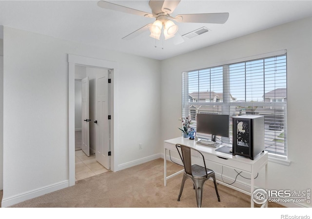 carpeted home office with baseboards, ceiling fan, and visible vents