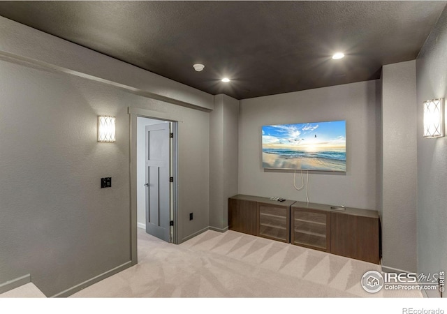 carpeted cinema with baseboards and recessed lighting