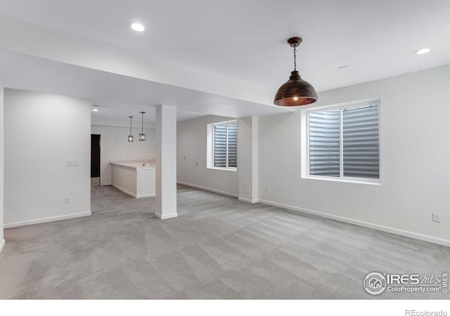 interior space featuring baseboards, recessed lighting, and light colored carpet