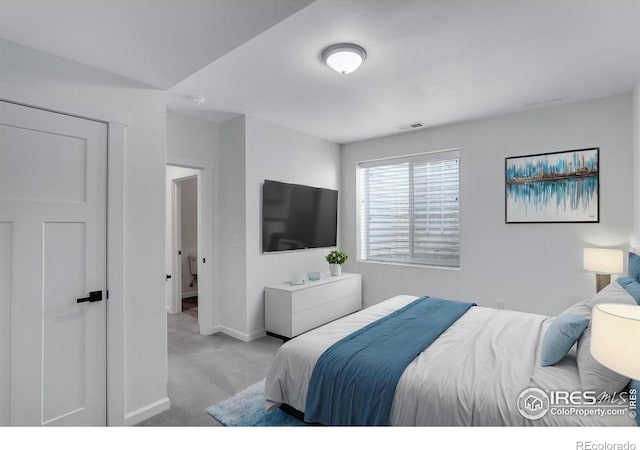 carpeted bedroom featuring baseboards and visible vents
