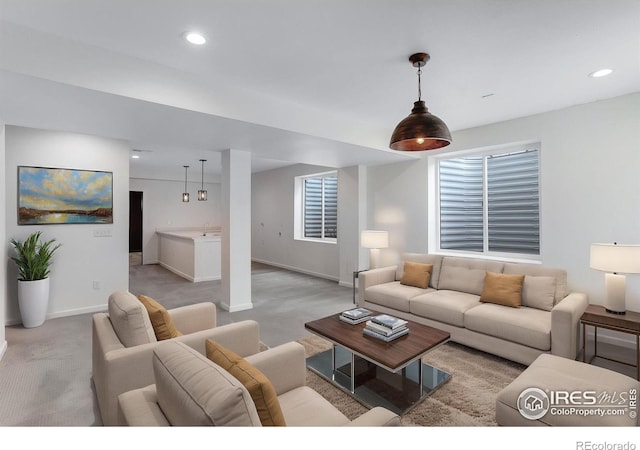 living area with recessed lighting, baseboards, and light carpet