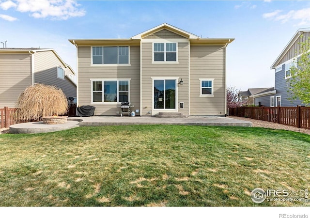 back of house with a yard, a patio, and a fenced backyard