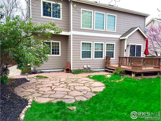 back of house with a lawn, a patio, and a deck