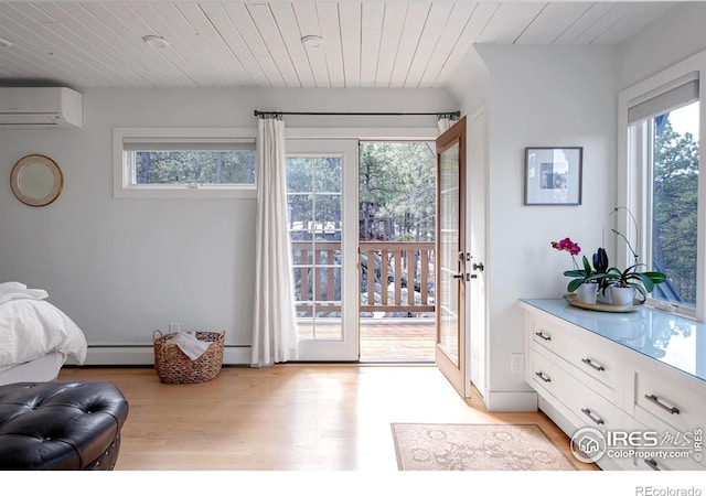 interior space featuring wooden ceiling, an AC wall unit, plenty of natural light, and light wood finished floors