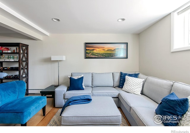 living area featuring recessed lighting, wood finished floors, and a baseboard radiator