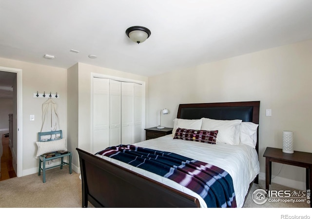 bedroom with a closet, baseboards, and carpet floors