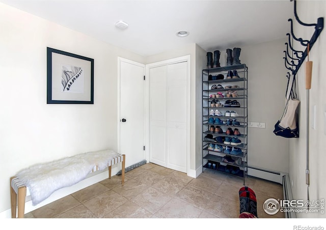 interior space with baseboards and a baseboard radiator