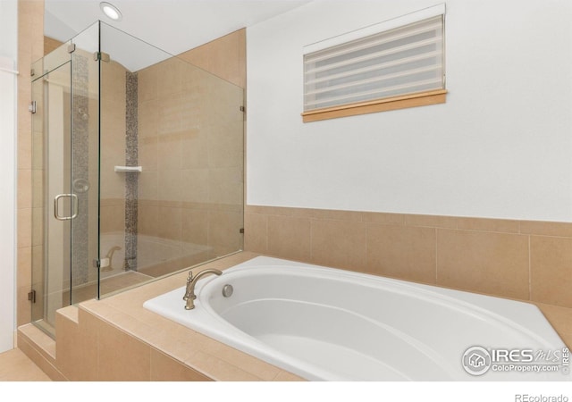 bathroom featuring recessed lighting, a shower stall, and a garden tub