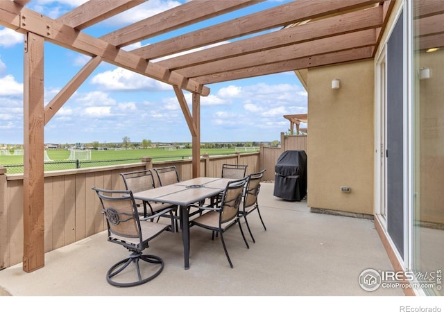 view of patio / terrace with fence, a pergola, a grill, and outdoor dining space
