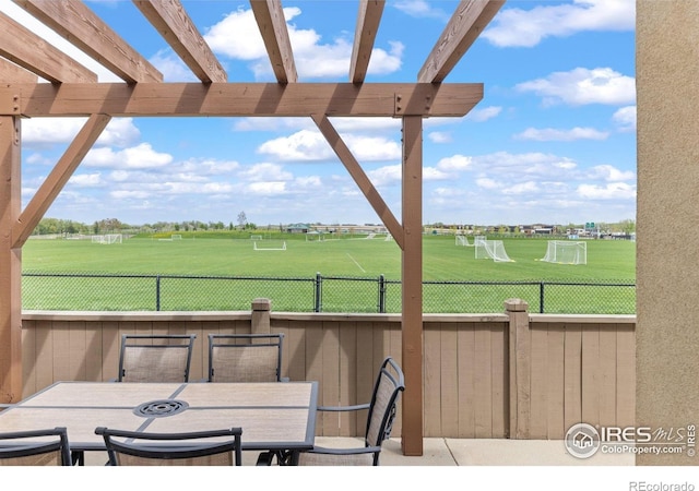 view of patio / terrace with fence, a pergola, view of golf course, and outdoor dining space