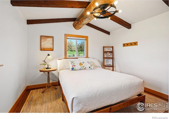 bedroom featuring baseboards, vaulted ceiling with beams, and wood finished floors