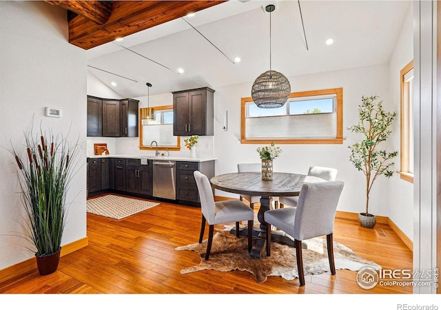 dining area featuring baseboards, lofted ceiling with beams, light wood finished floors, and recessed lighting