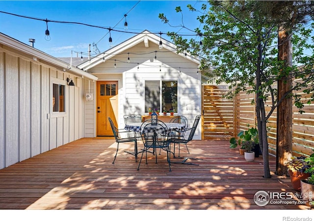 wooden deck featuring outdoor dining area and fence