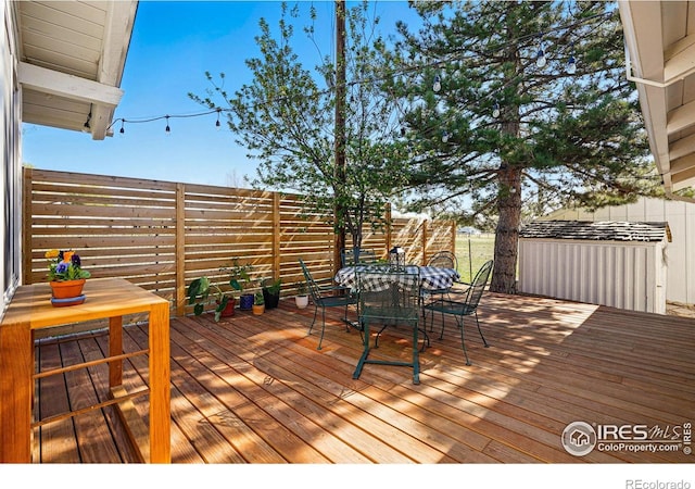 wooden deck featuring fence and outdoor dining space