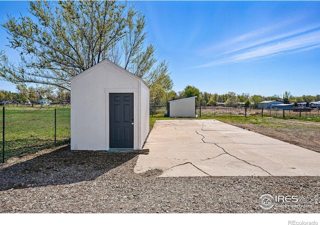 view of shed featuring fence