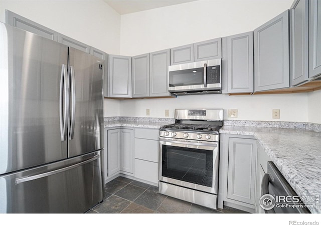 kitchen featuring light countertops, gray cabinets, and stainless steel appliances