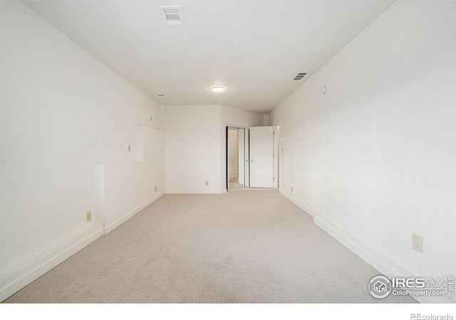 unfurnished room with baseboards, carpet flooring, and visible vents