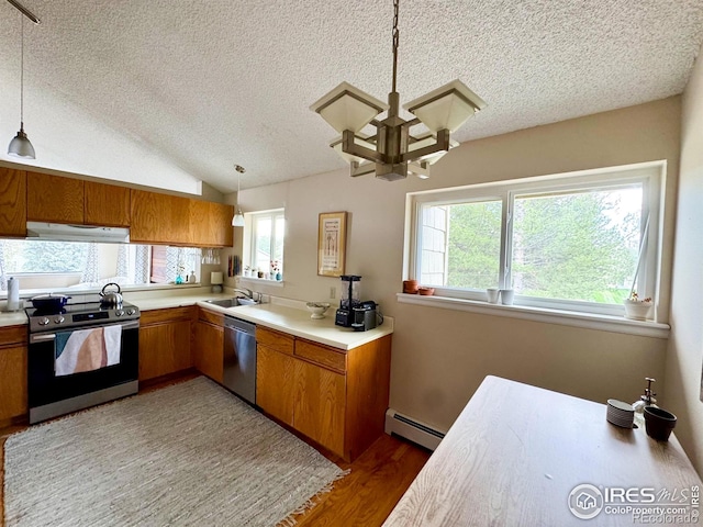 kitchen with appliances with stainless steel finishes, ventilation hood, a textured ceiling, brown cabinetry, and a baseboard heating unit