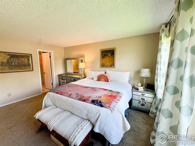 carpeted bedroom featuring a textured ceiling and baseboards