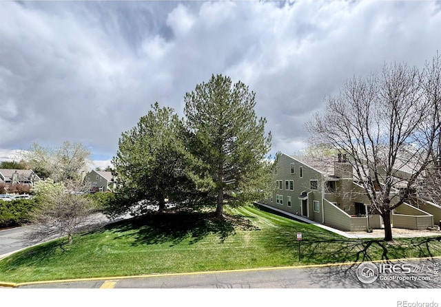 view of side of property with a lawn