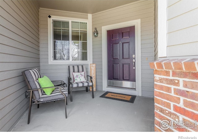 view of exterior entry with covered porch