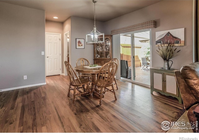 dining room with recessed lighting, baseboards, a chandelier, and wood finished floors