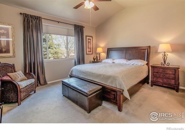 bedroom featuring baseboards, light carpet, and lofted ceiling